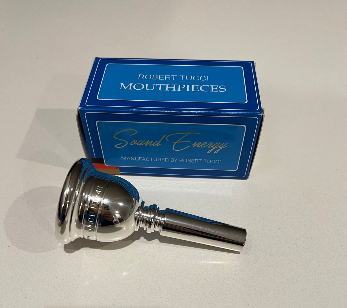 Silver Robert Tucci RT-48 Tuba Mouthpiece with blue Robert Tucci box.