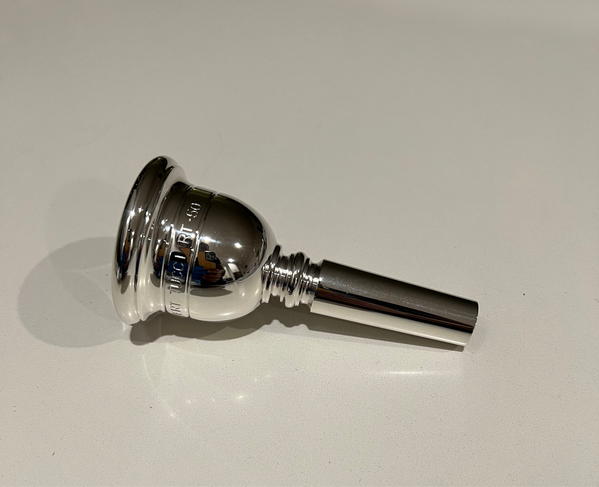 Silver tuba mouthpiece on a white background