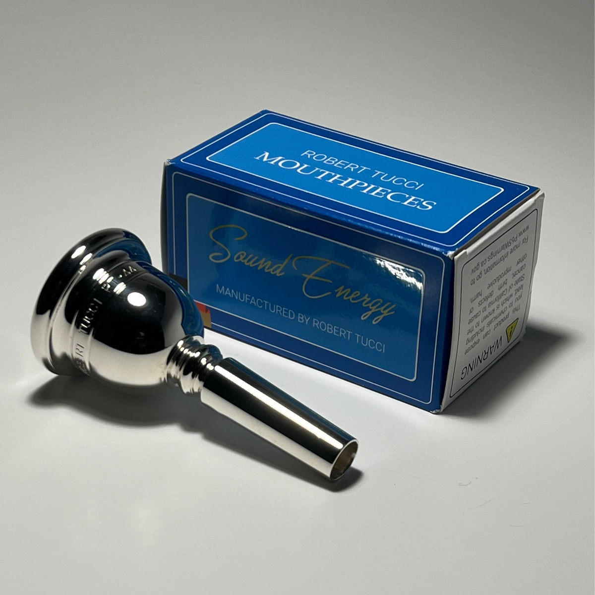 Robert Tucci RT-44 Tuba Mouthpiece with blue box with “Robert Tucci Mouthpieces” printed on it.